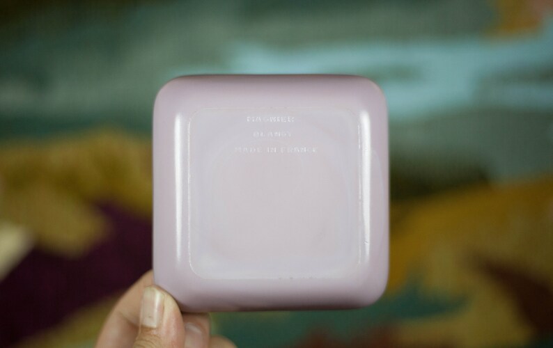 May include: A square, pale lavender ceramic dish with the text "Made in France" on the bottom.