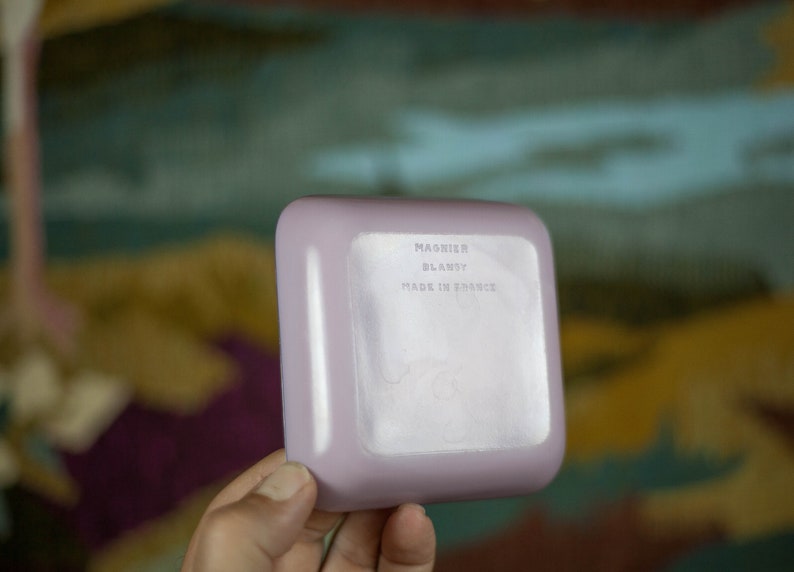 May include: A light purple square dish with the text "MAGNIER BLANZY MADE IN FRANCE" on the bottom.