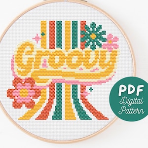 May include: A digital cross stitch pattern featuring the word "Groovy" in a retro font with colourful stripes and flowers. The pattern is available as a PDF download.