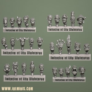 Può includere: Una collezione di teste fantasy in miniatura con vari design grotteschi. Ogni testa è montata su un piccolo supporto, con il testo "Imitation of Life Miniatures" sotto ogni fila. L'indirizzo del sito web "WWW.IOLMINIS.COM" è in basso.