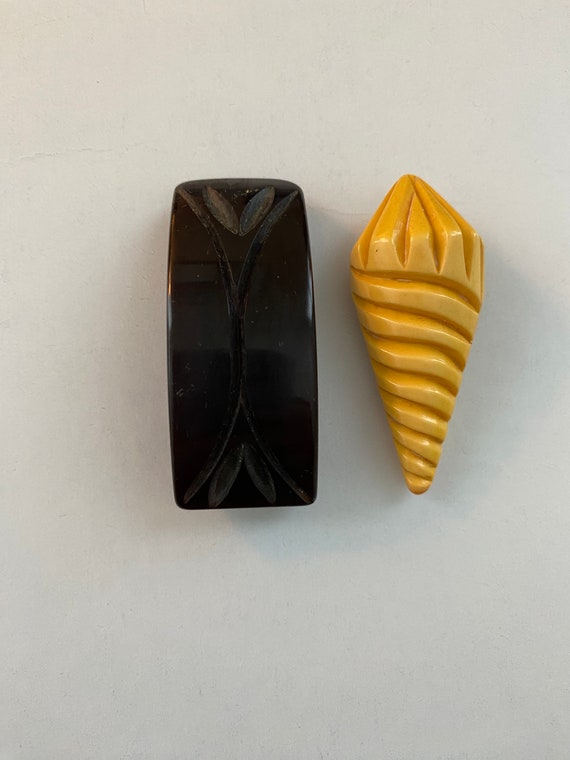 Two wonderful Bakelite carved clips. dark brown an