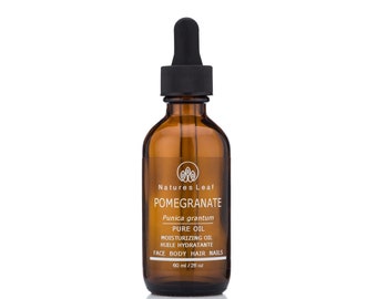 May include: A brown glass bottle with a black dropper top. The bottle is labeled "Natures Leaf Pomegranate Punica grantum Pure Oil Moisturizing Oil Huile Hydratante Face Body Hair Nails 60 ml / 2 fl oz"