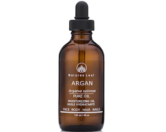 May include: A brown glass bottle with a black dropper top. The bottle is labeled "Natures Leaf Argan Argania spinosa Pure Oil Moisturizing Oil Huile Hydratante Face Body Hair Nails 120 ml / 4 fl oz".