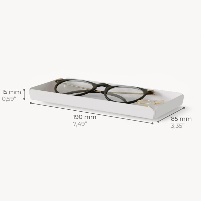 May include: White rectangular tray with rounded edges, measuring 7.49 inches long and 3.35 inches wide, designed to hold glasses or other small items.
