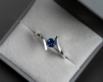 Sterling silver lab created blue sapphire bypass ring