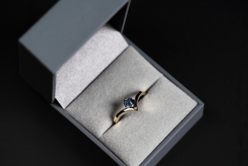 14K yellow gold alexandrite chevron ring with accent diamond in a jewelry box