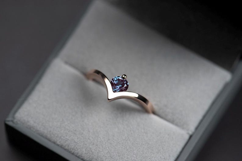 14K rose gold alexandrite chevron ring with accent diamond in a jewelry box