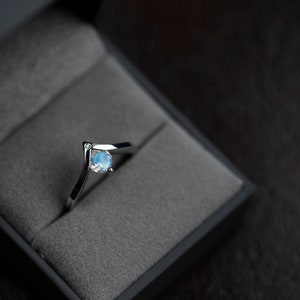 Sterling silver moonstone engagement chevron ring in a jewelry box