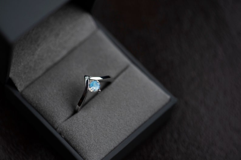 Sterling silver moonstone engagement chevron ring in a jewelry box