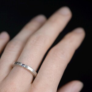 Sterling silver lab created alexandrite tension promise unisex ring on finger