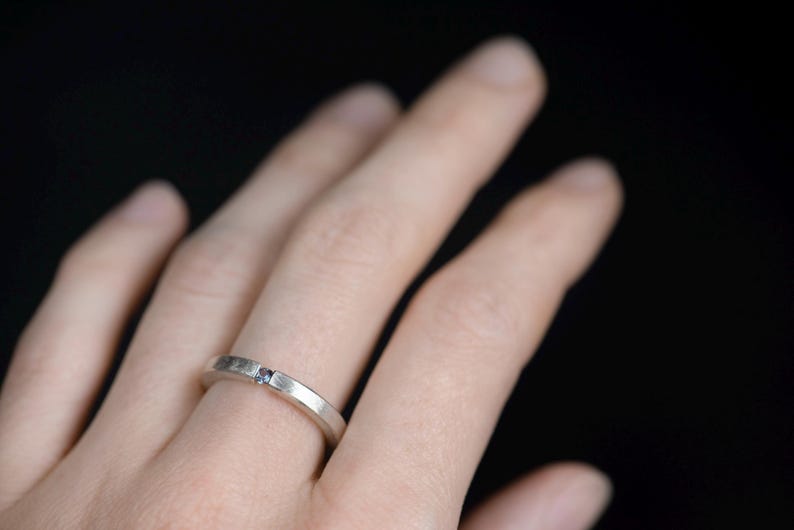 Sterling silver lab created alexandrite tension promise unisex ring on finger