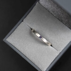 Sterling silver lab created alexandrite tension promise unisex ring in a jewelry box