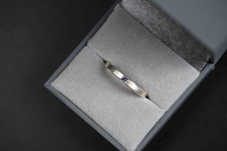 Sterling silver lab created alexandrite tension promise unisex ring in a jewelry box