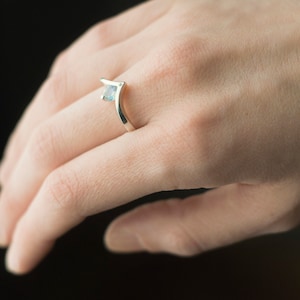 Sterling silver moonstone and diamond engagement chevron ring on hand