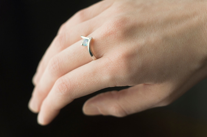 Sterling silver moonstone and diamond engagement chevron ring on hand