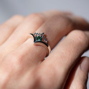 Sterling silver alexandrite chevron band and sterling silver green moissanite chevron ring on hand