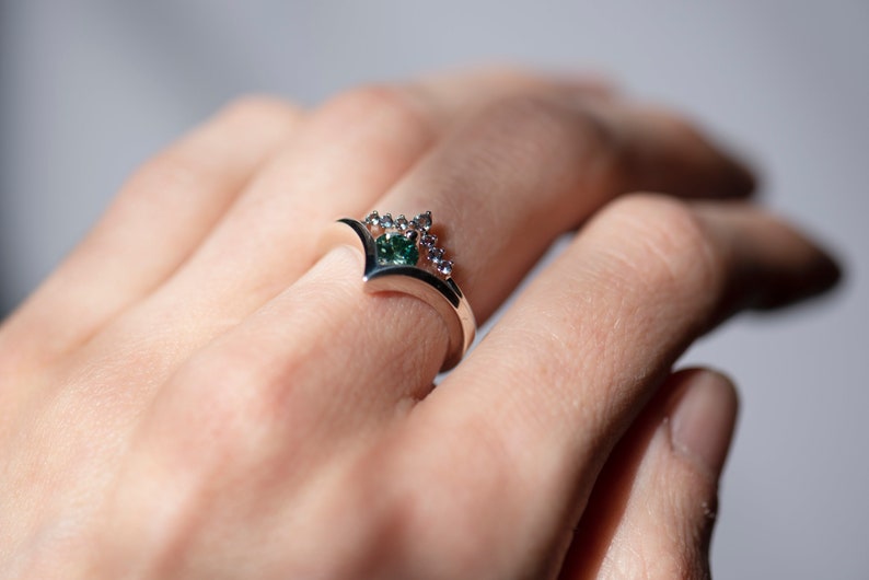 Sterling silver alexandrite chevron band and sterling silver green moissanite chevron ring on hand