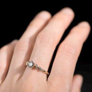 14K gold salt and pepper diamond and white diamonds engagement ring on finger