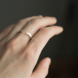 Sterling silver two little diamonds open curved wedding band on hand