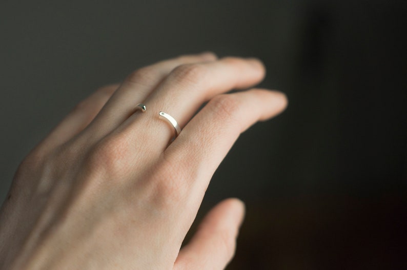 Sterling silver two little diamonds open curved wedding band on hand