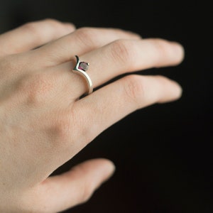 Sterling silver rhodolite garnet engagement chevron ring on hand