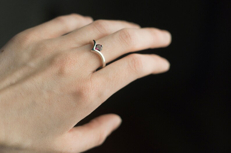 Sterling silver rhodolite garnet engagement chevron ring on hand