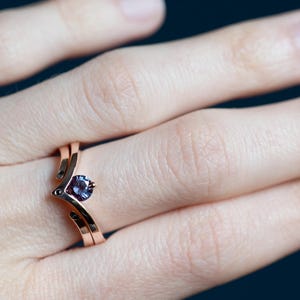 14K rose gold two little black diamonds open curved wedding band and 14K rose gold alexandrite and black diamond chevron ring on finger