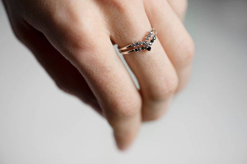 Sterling silver black diamond and alexandrite chevron stacking rings on hand
