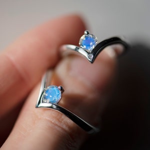Two sterling silver moonstone engagement chevron rings - one with accent diamond, second without.