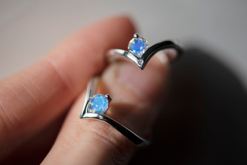 Two sterling silver moonstone engagement chevron rings - one with accent diamond, second without.