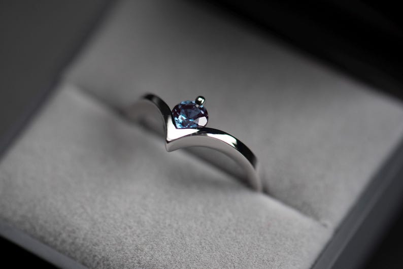 14K white gold alexandrite chevron ring with accent diamond in a jewelry box