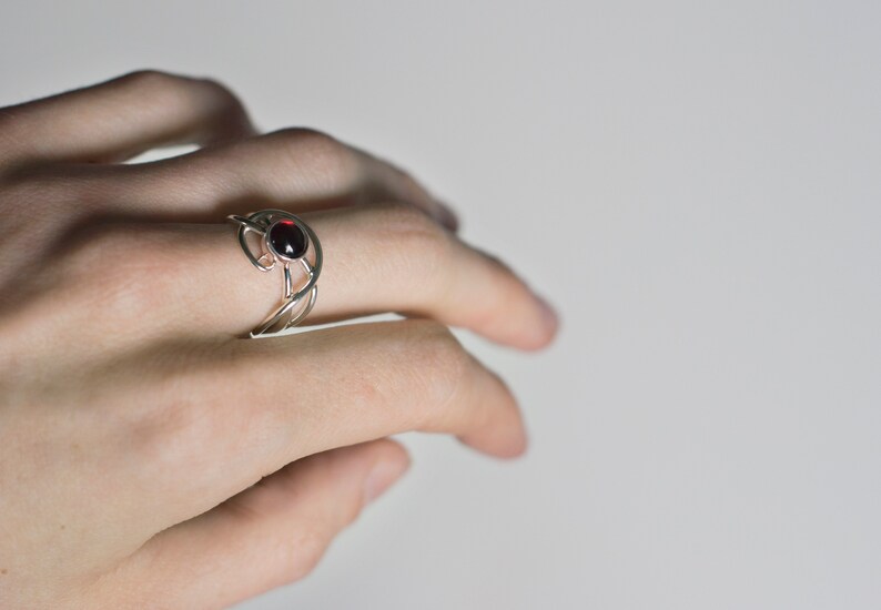 Sterling silver natural red garnet twisted ring on hand