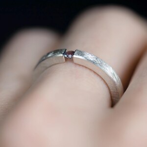 Sterling silver lab created alexandrite tension promise unisex ring onfinger