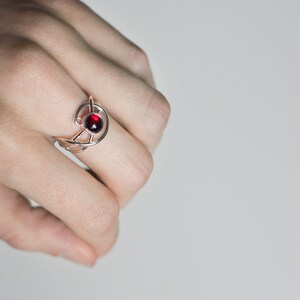 Sterling silver natural red garnet twisted ring on hand