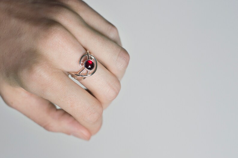 Sterling silver natural red garnet twisted ring on hand