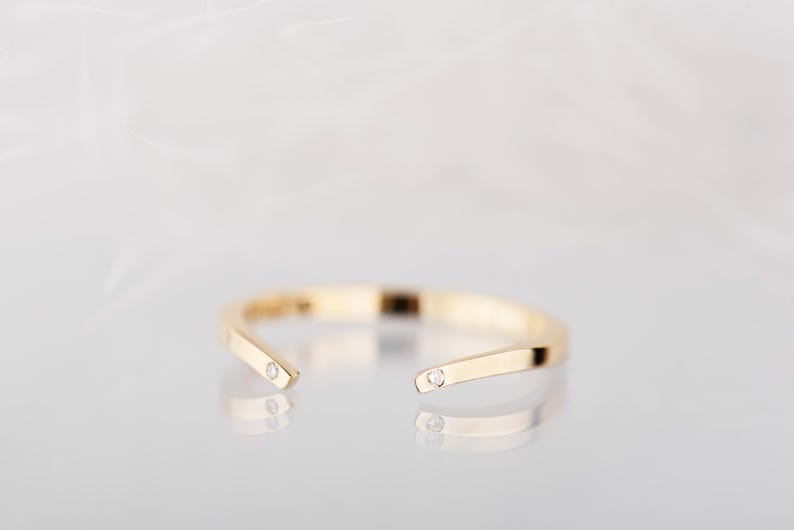 14K yellow gold two little diamonds open curved wedding band