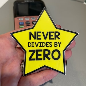 May include: A yellow star-shaped sticker with the text "NEVER DIVIDES BY ZERO" in black lettering.