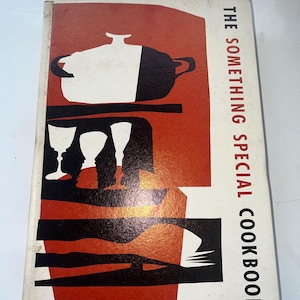 May include: Vintage cookbook titled "The Something Special Cookbook" with a retro design. The cover features a white and black pot, wine glasses, and a red and black background. Published by The Ward Ritchie Press.