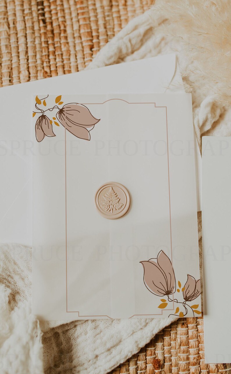 May include: A white card with a decorative border and floral illustrations. A wax seal with a tree design is in the center of the card.