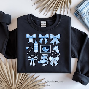 Puede incluir: Sudadera negra con lazos azul claro y gráficos con temática de ultrasonido. El diseño incluye lazos, una botella de gel de ultrasonido, una imagen de ultrasonido y una máquina de sonograma. La sudadera es de la marca Gildan.
