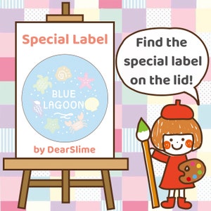 May include: A white easel with a blue and white circle label that says "BLUE LAGOON" with a variety of sea creatures and shells. The text "Special Label" is above the circle and the text "by DearSlime" is below the circle. A cartoon girl with red hair and a red beret is holding a paintbrush and a paint palette. The text "Find the special label on the lid!" is in a speech bubble above the girl.