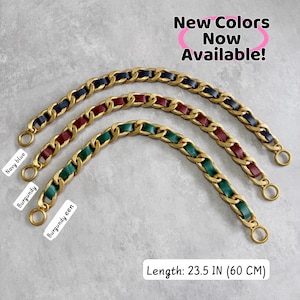 May include: Three gold-tone metal chain bag straps with woven leather strips in navy blue, burgundy, and green. Each strap features circular end rings and measures 23.5 inches in length. Text reads: New Colors Now Available! Navy blue, Burgundy, Burgundy een.