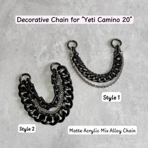 Op de afbeelding: Twee decoratieve kettingen voor Yeti Camino 20 tassen, gelabeld Style 1 en Style 2. Elke ketting bevat een mix van matzwarte acrylschakels en zilverkleurige legeringskettingen bevestigd aan metalen ringen. De tekst luidt Decorative Chain for Yeti Camino 20.