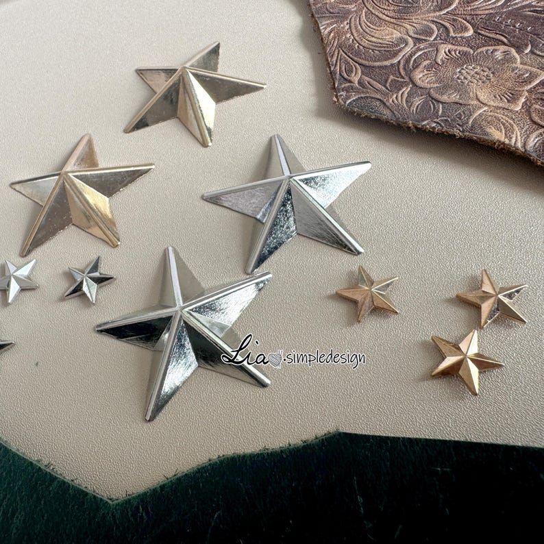 May include: Assortment of gold and silver star-shaped embellishments. The stars are various sizes and have a metallic finish.