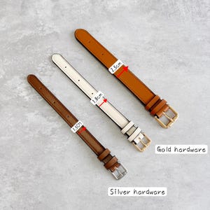 May include: Three watch straps in different colors and widths. One brown strap is 1.5cm wide with silver hardware, one cream strap is 1.8cm wide with gold hardware, and one tan strap is 2.5cm wide with gold hardware. Each strap features a buckle.