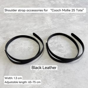 May include: Two black leather shoulder strap accessories for a Coach Mollie 25 Tote bag. The straps are 1.3 cm wide and have an adjustable length of 65-75 cm.