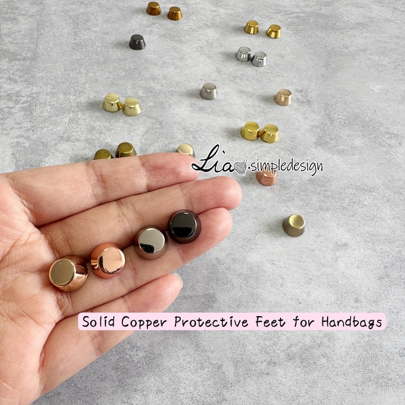 May include: Various solid copper protective feet for handbags in gold, rose gold, silver, and black finishes. The image includes the text "Solid Copper Protective Feet for Handbags".