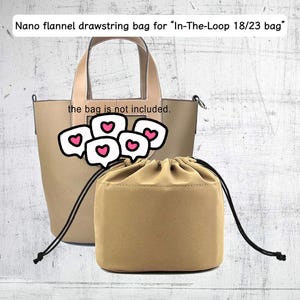 May include: A tan flannel drawstring bag insert positioned in front of a tan leather tote bag. The text on the image reads: Nano flannel drawstring bag for In-The-Loop 18/23 bag and the bag is not included. The insert has black drawstrings.