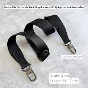 May include: A black crossbody strap with gun black hardware. The strap is adjustable and detachable, with a width of 4 cm and a length that adjusts from 93 to 133 cm. The strap is designed to be compatible with Keepall 25 bags.