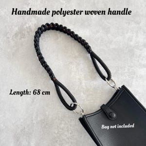 May include: Handmade black polyester woven handle with red detailing, attached to a black bag. The handle is 68 cm (26.7 inches) long. The bag is not included.